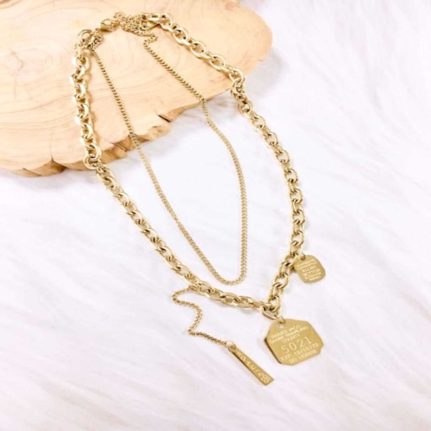 Stainless Steel Letter Trend Multi Strand Necklace with 14K gold plating on white background.