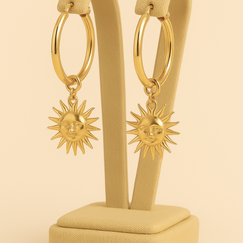 Titanium steel sun drop earrings with engraved sun motif and polished finish.