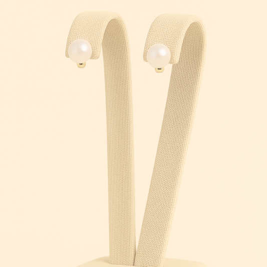 Pearl stud earrings in gold featuring luxurious white pearls by NueJewelz.