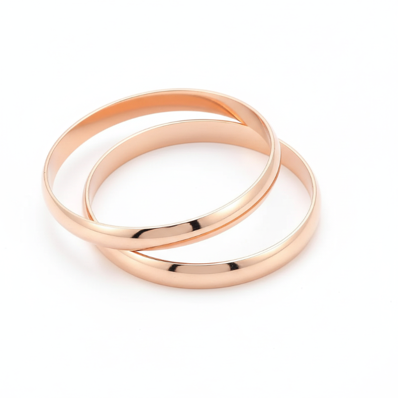Set of two polished rose gold plated stainless steel bold statement bangles with smooth finish and modern design