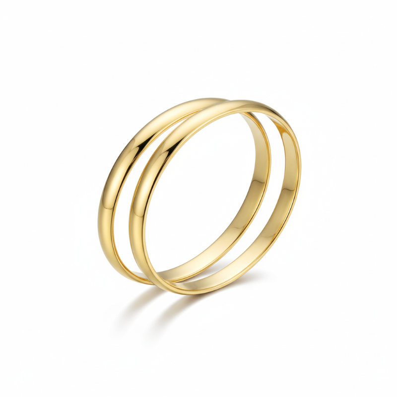 Two sleek gold-plated stainless steel bold statement bangles with polished finish