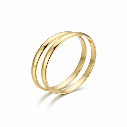 Two sleek gold-plated stainless steel bold statement bangles with polished finish