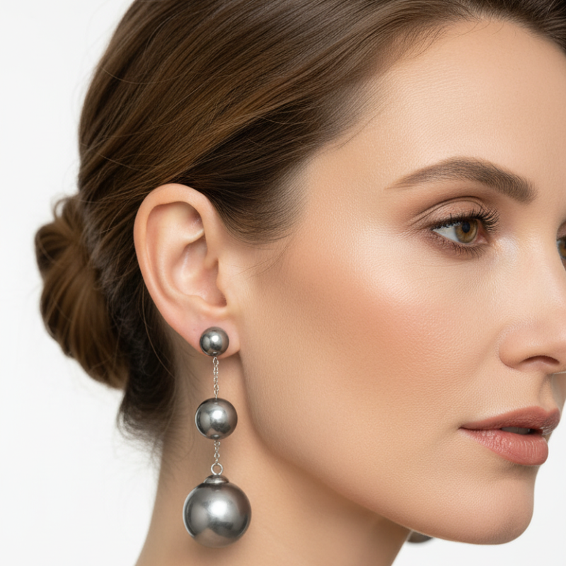 Elegant round stainless steel bead drop trio earrings with polished silver-tone spheres and delicate chain links.