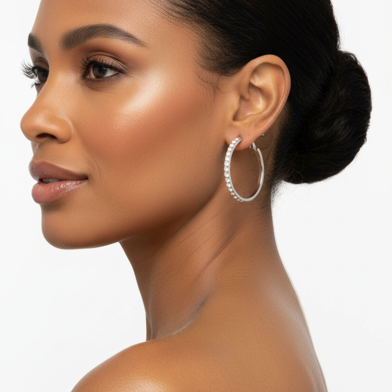Elegant stainless steel rhinestone hoop earrings worn by woman with sleek hairstyle