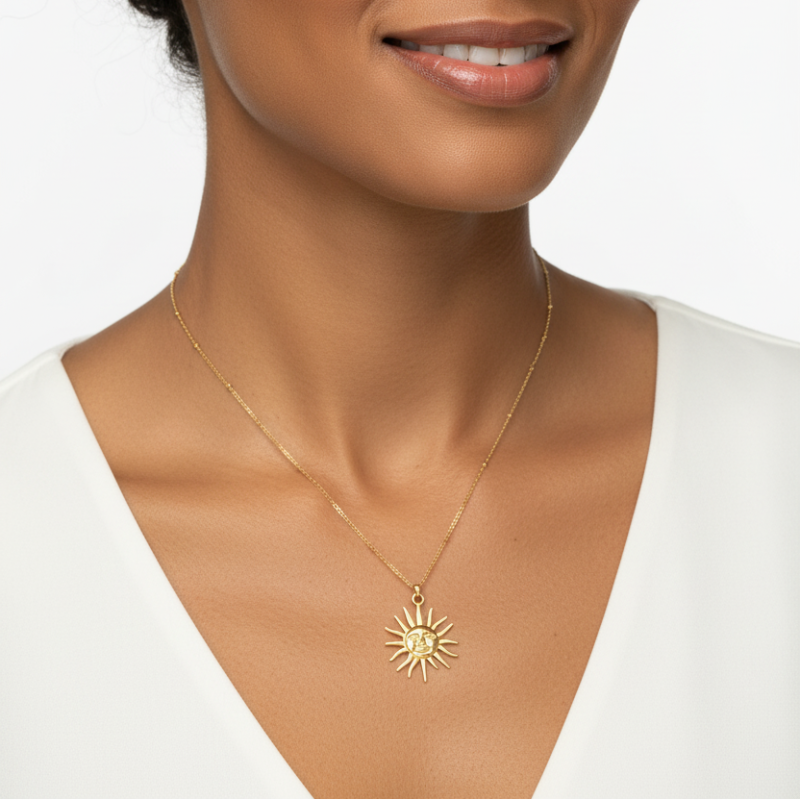 The Sun Pendant Necklace gold plated sun face pendant on delicate chain worn on neck