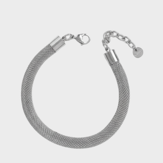 Silver mesh bracelet on a light gray background