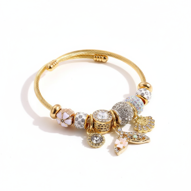Gold-plated twisted wire bracelet with rhinestone-studded classic four-leaf clover charm and fish tail detailing