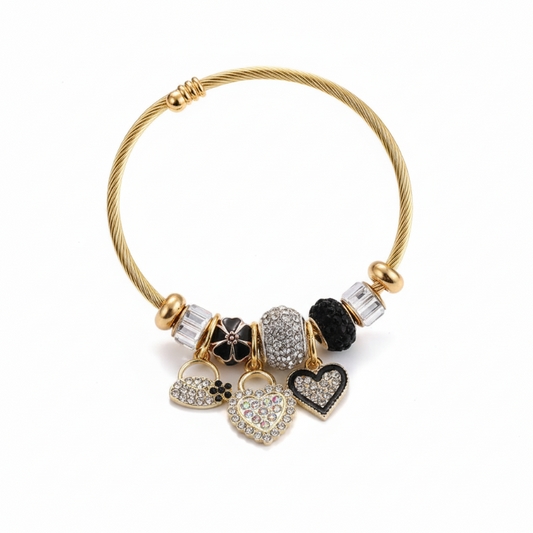 Gold twisted wire bracelet with heart shape shell charm and rhinestone accents